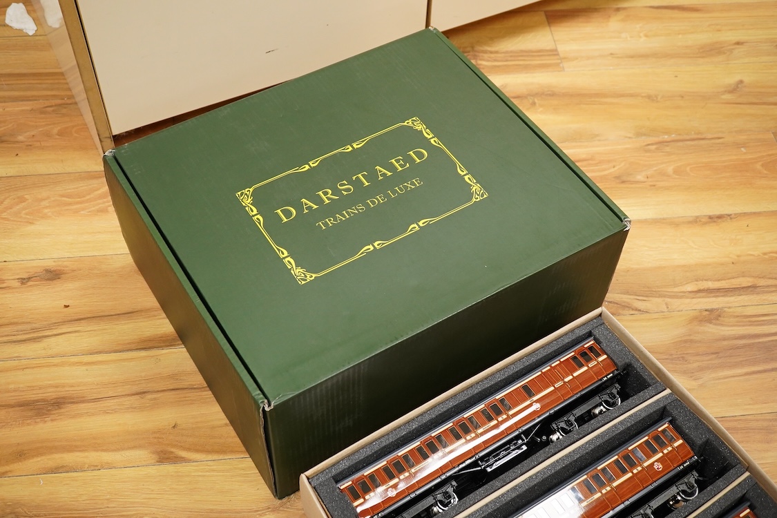 A boxed 0 gauge Darstaed tinplate Metropolitan Railway set of bogie coaches, a rake of five coaches in teak livery including; two Brake Thirds, two Full Thirds, and a Full First, fitted with internal lighting throughout